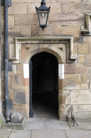 One of the doorways in the courtyard of Durham Castle, showing the white paint, useful during black-outs, that has been periodically repainted since World War II.